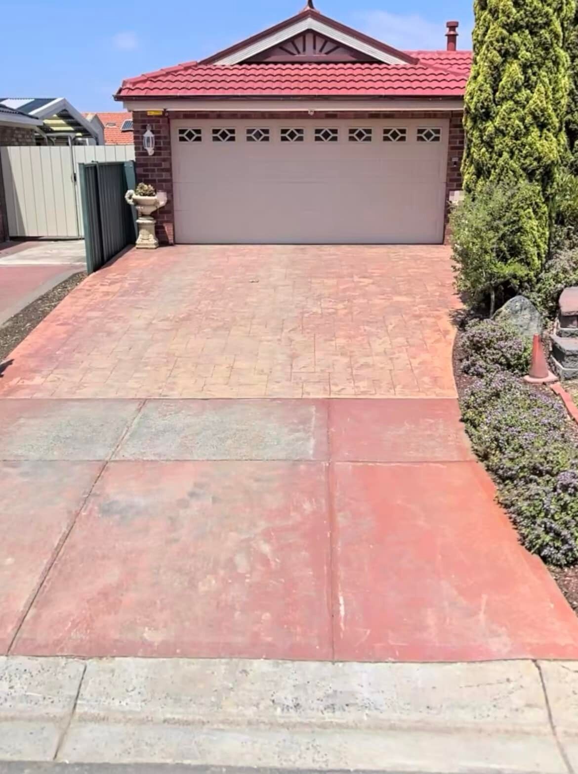 Red concrete driveway, stencilled near the garage and plain near the street