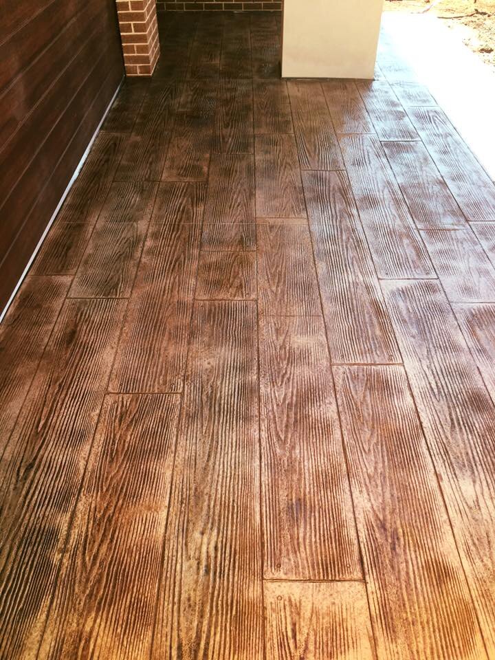 Close-up of brown timber-look stencilled concrete under a porch