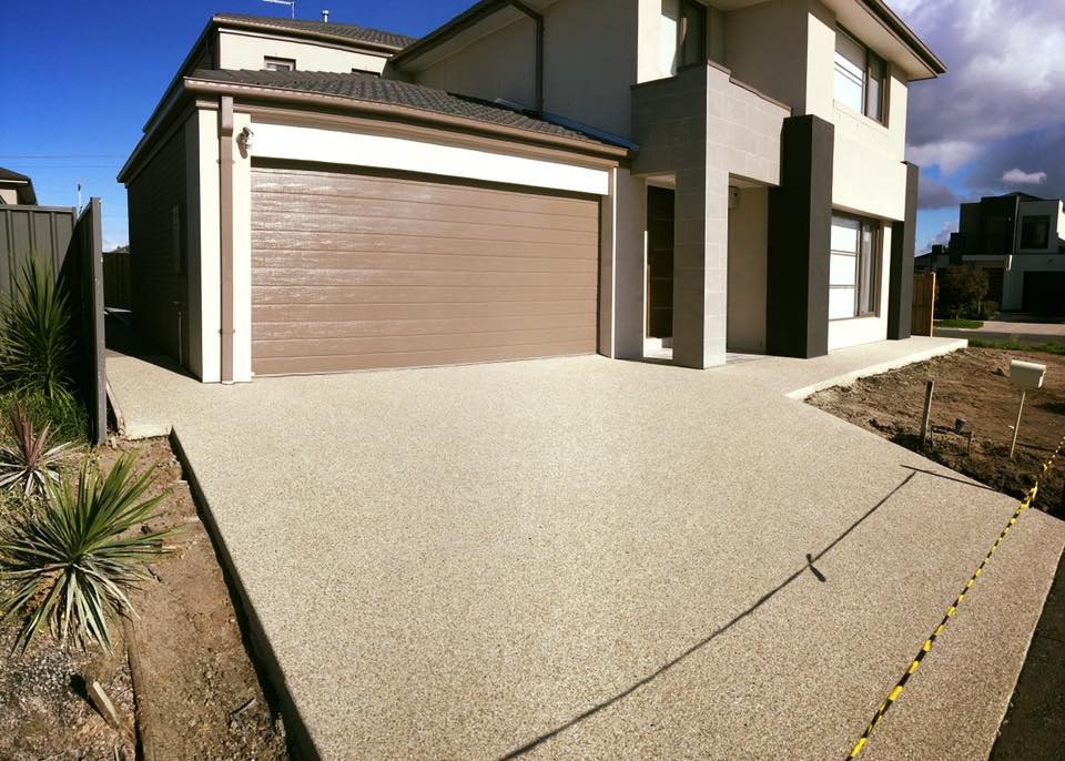 Exposed aggregate driveway in front of a new double-storey home